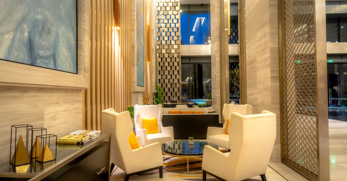 Luxurious hotel lobby featuring comfortable armchairs and sophisticated decor.