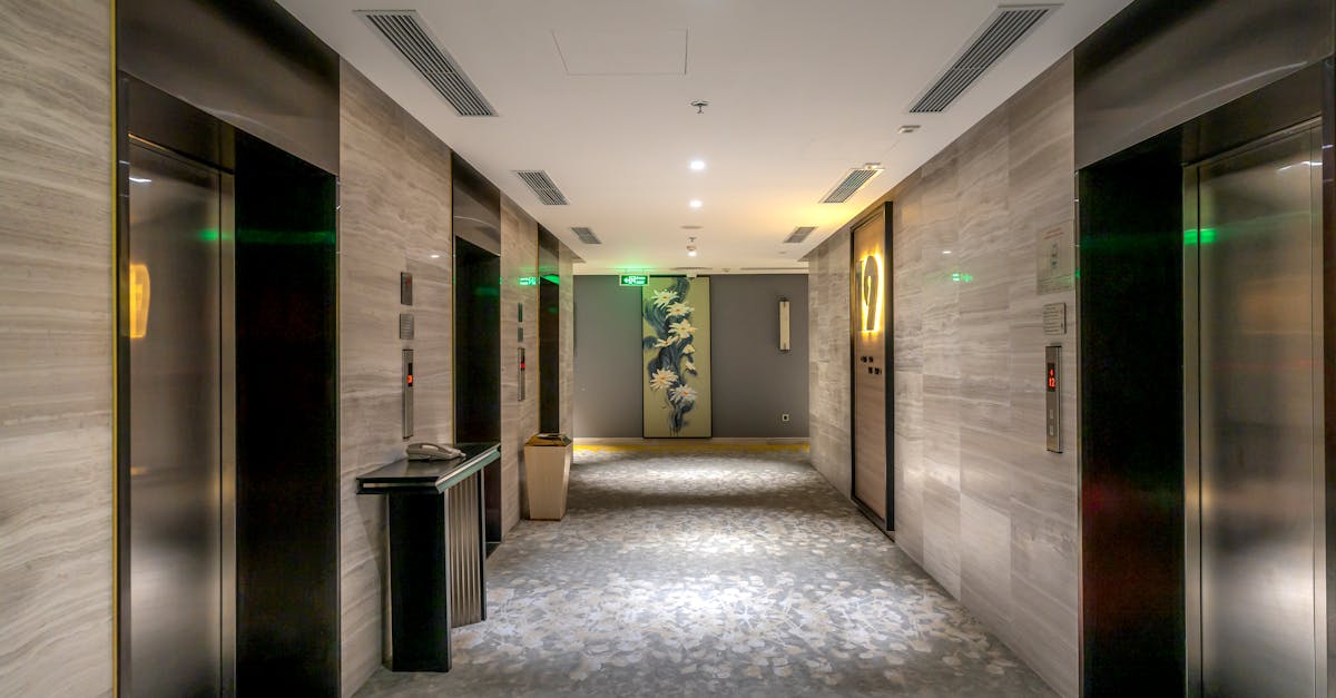 Spacious hotel hallway with elevators and contemporary decor.
