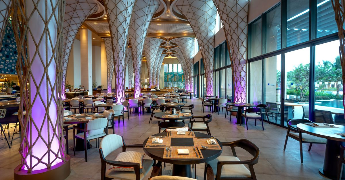 Spacious modern restaurant interior with unique architectural design and ambient lighting.