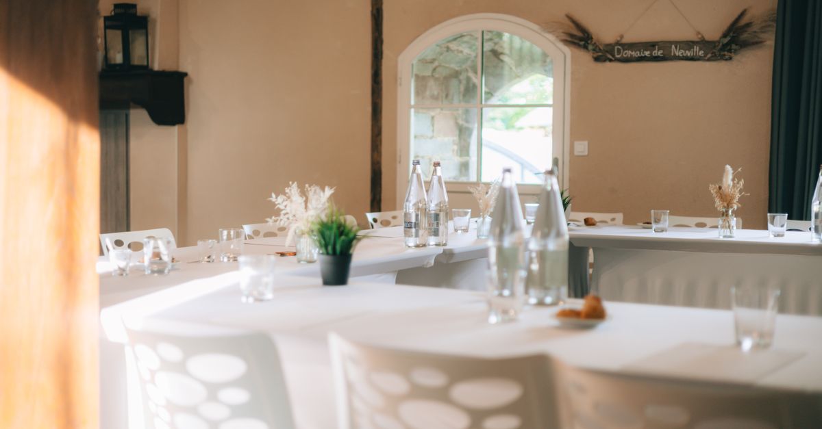 Elegant banquet room with empty tables and decor, ready for an event.