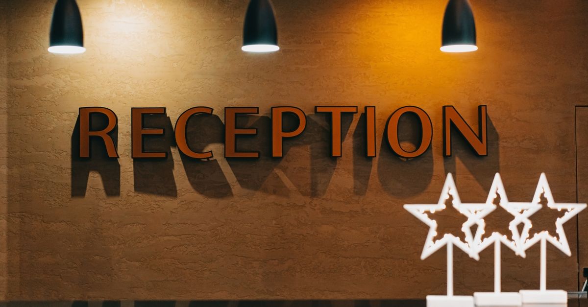 Elegant hotel reception area with illuminated signage and decor.
