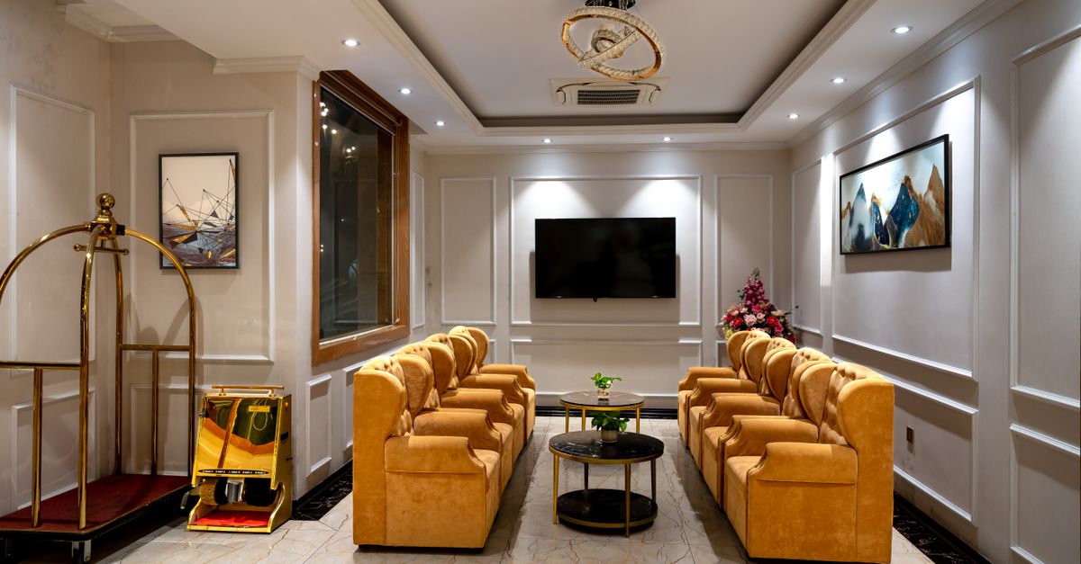 Luxurious hotel lobby featuring stylish armchairs, lighting, and decor.