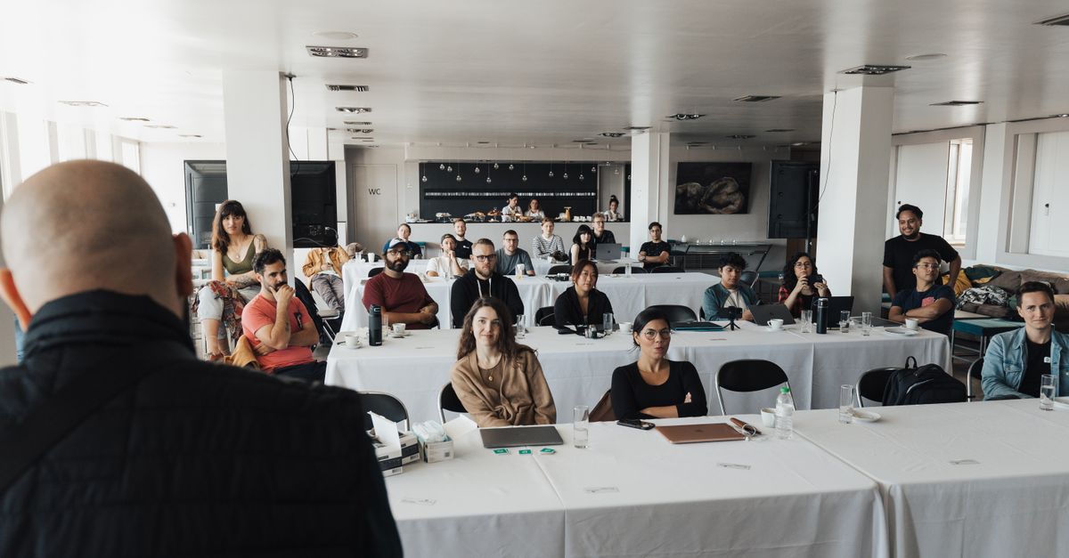 A diverse group of business professionals attending a presentation in a modern conference room.