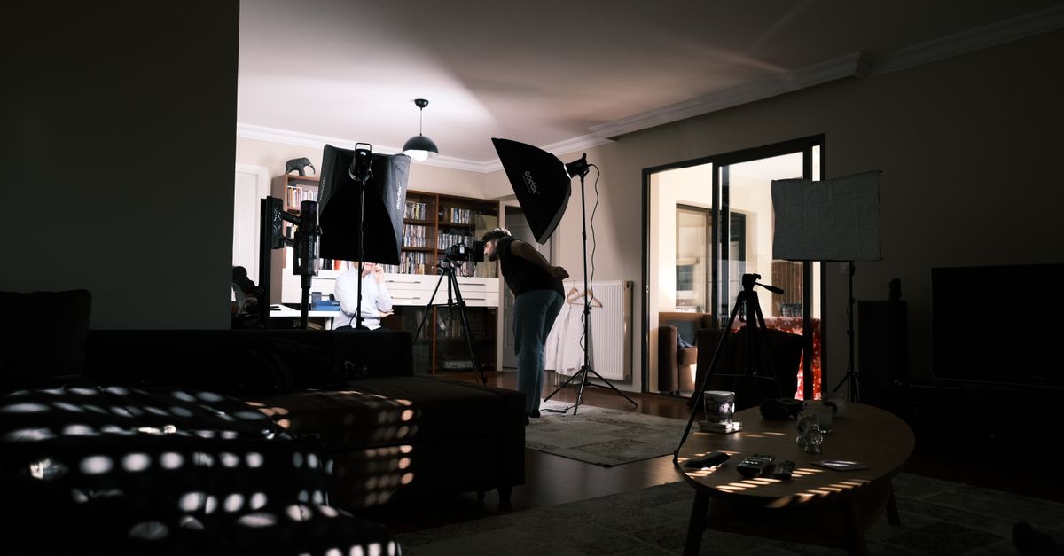 A cozy home studio with professional lighting equipment for a photo session.