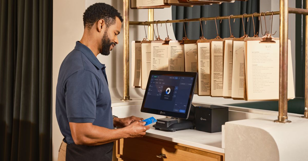 Server using a point of sale system to process a credit card payment in a restaurant setting.